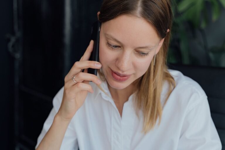 Woman talking on her mobile phone at home