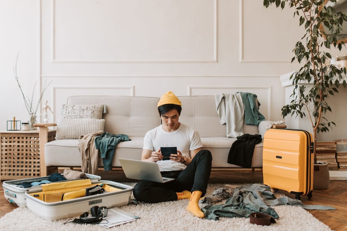 Man setting up his phone while packing for a trip