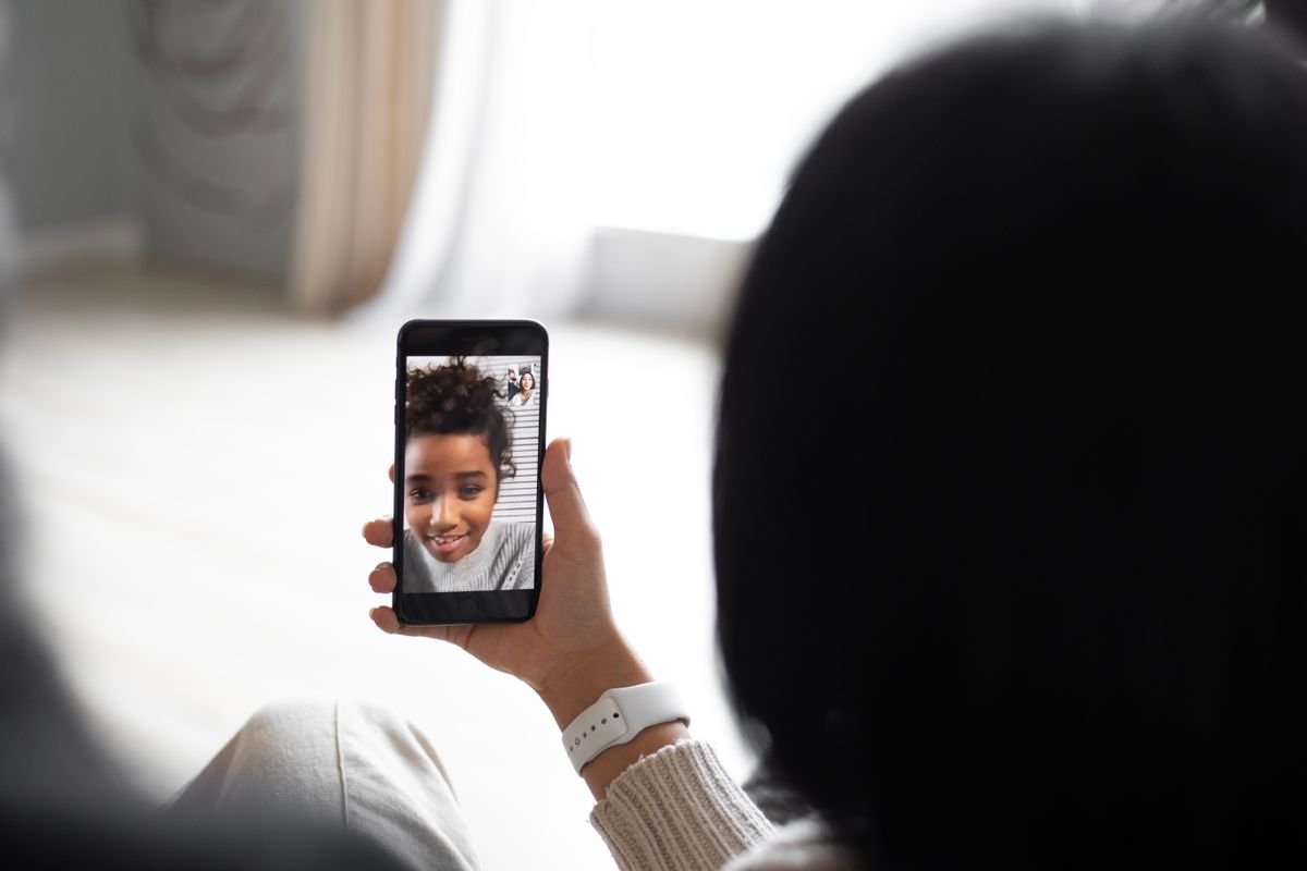 Person on a video call with a smiling child on their phone