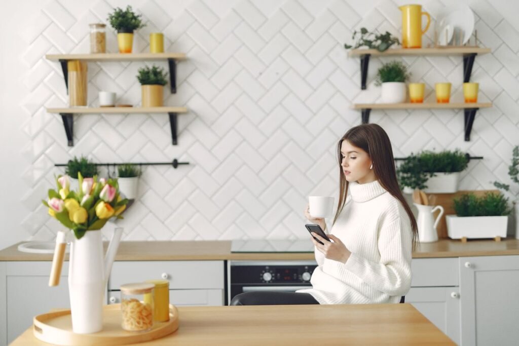 SIM Only Plans From 5GB to 120GB on One Price List Woman checking her smartphone over coffee in a bright kitchen
