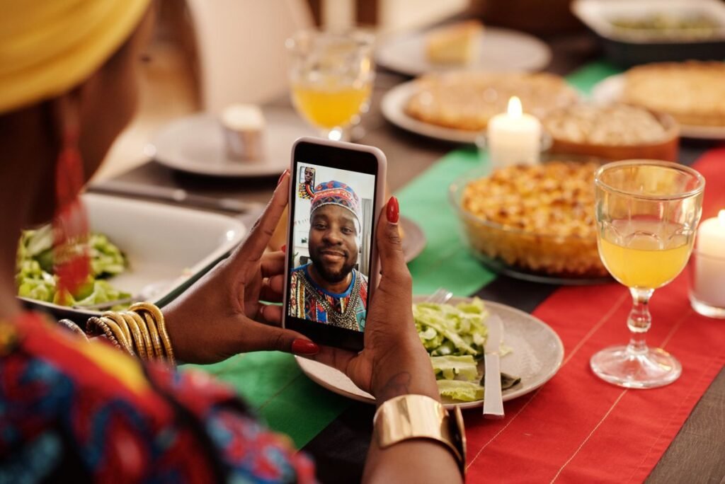 Woman on a video call with a relative during a family dinner